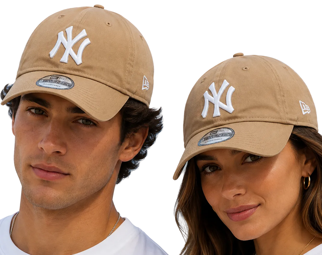 A man and a woman wearing tan New York Yankees baseball caps with white embroidered logos, photographed outdoors against a light blue sky.