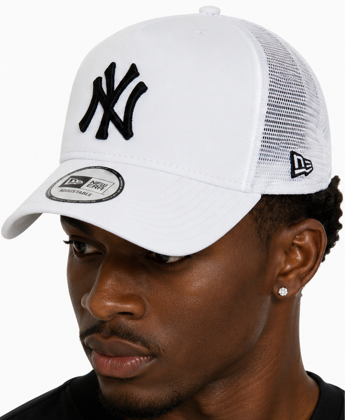 A man wearing a white New York Yankees trucker hat, shown in side profile and back view against a light gray background.