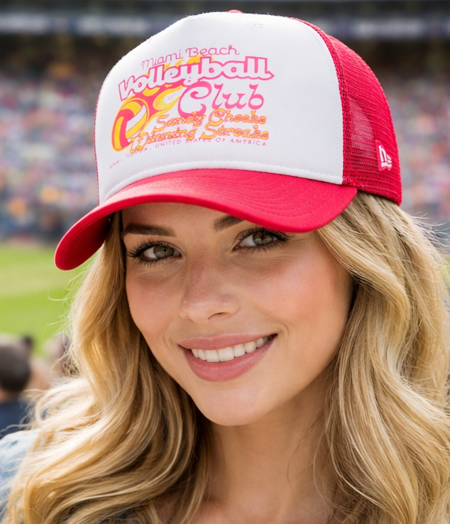 Woman wearing a red and white baseball cap with a stadium in the background