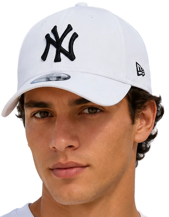 A close-up of a man wearing a white New York Yankees baseball cap with a black embroidered NY logo on the front and a black New Era flag logo on the side, set against a light blue sky background.