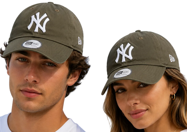 Two models wearing New Era 9FIFTY baseball caps in olive green with a white New York Yankees logo, set against a clear blue sky.