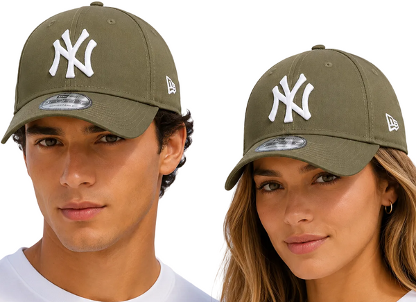 Two models wearing olive green New Era baseball caps with a white New York Yankees logo, set against a light blue sky background.